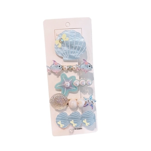 Five-piece ocean theme hair clips set with shells and fish on a white card display