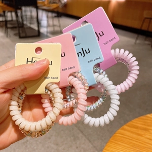 Set di elastici per capelli a spirale colorati su confezione in carta per donne e ragazze