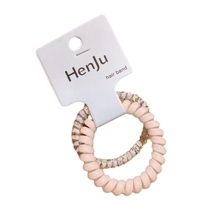 Set di due elastici per capelli a spirale rosa e glitterati su carta bianca