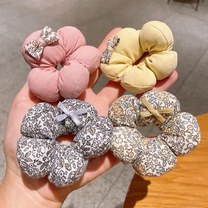 Set of four floral fabric hair scrunchies with sweet bows in pink, yellow and patterns