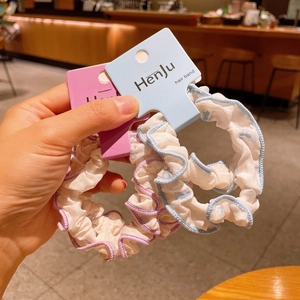 Floral print scrunchies set with ruffled edges in light blue and lavender colors
