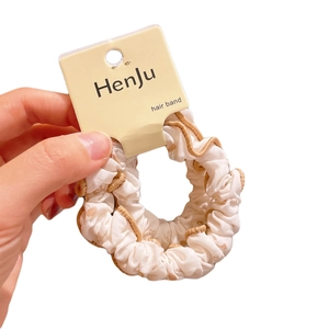 Polka dot floral hair scrunchie in white satin fabric with beige scalloped edge trim
