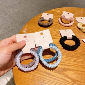 Close-up of colorful soft plush scrunchies in candy colors on card display