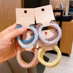 Close-up of vibrant woven knit elastic hair scrunchies in assorted candy colors