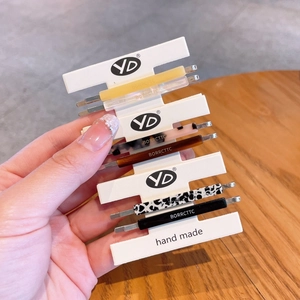Set of 6 vintage acetate hair clips with diverse patterns on a white display card
