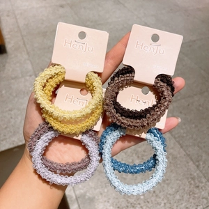 Set of four colorful lace-edged elastic plush hair scrunchies on display cards