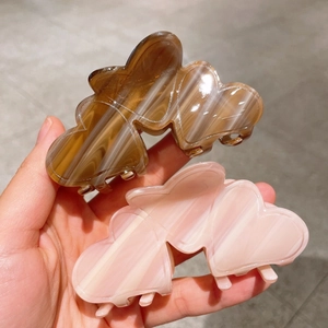 Elegant acetate marble heart claw clips in coffee and light pink for secure hair styling