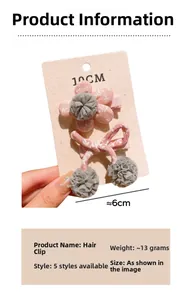 Close-up of pink floral flower hair clip and bow with mesh pompoms for girls