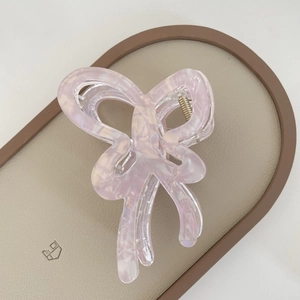 Macro shot of jelly purple butterfly hair claw clip with elegant marble texture detail