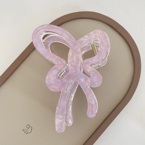 Close-up of lilac marble textured butterfly claw clip with golden metal spring