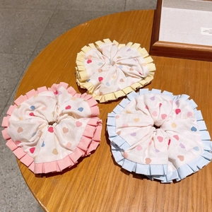Set of three colorful heart pattern scrunchies with ruffles for girls hair styling