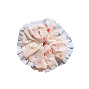 Kids colorful heart pattern scrunchie with blue ruffle edge on a white background