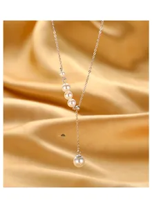 Detail of silver Y-shaped necklace featuring five lustrous pearls on golden satin