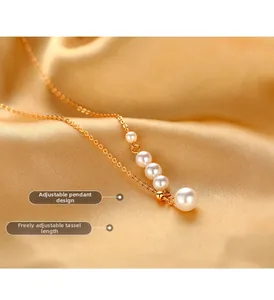 Detailed close-up of golden pearl tassel necklace with adjustable length design