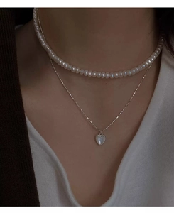Dettaglio collana doppia in argento S925 con perle e pendente a cuore in conchiglia