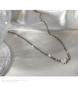 Detail of 925 sterling silver butterfly pendant necklace with sparkling tennis chain