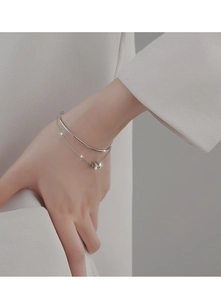 Macro detail of S925 sterling silver double-layered bracelet with a micro-pave ring pendant