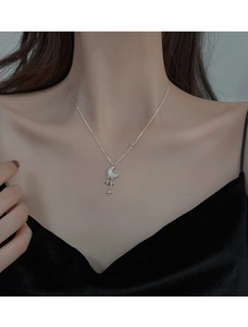 Gros plan détaillé du collier en argent s925 avec lune et étoiles scintillantes sur le cou