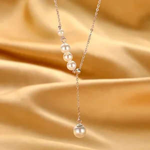 Elegant sterling silver Y-shaped pearl necklace on golden silk background