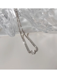 Detailed macro view of 925 sterling silver butterfly necklace with sparkling zircons