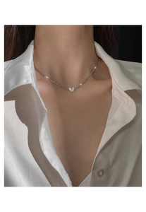 Close-up of 925 sterling silver butterfly necklace worn on neck with white silk shirt