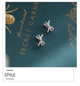 Macro shot of bow earrings with pavé set cubic zirconia and silver finish