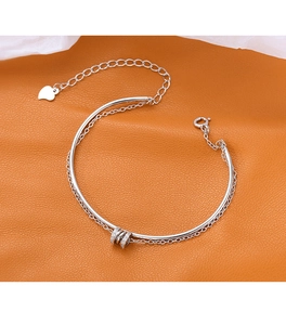 Close-up of S925 sterling silver double-layer bracelet with sparkling zircon ring charms