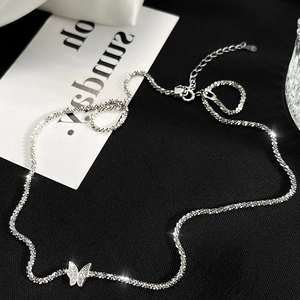 Elegant 925 sterling silver butterfly necklace with shimmering stones on black fabric