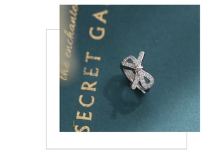 Close-up of a silver bow ring with shimmering cubic zirconia on an elegant background
