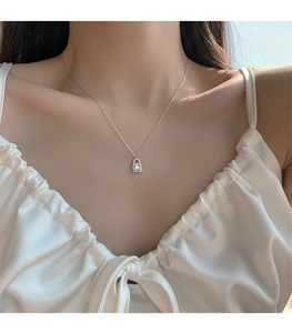 Detail of silver square padlock pendant necklace with sparkling cubic zirconia stones