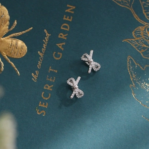 Elegant bow knot hoop earrings in silver with shimmering pave crystals for women
