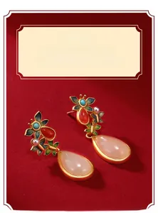 Close-up of traditional Chinese drop earrings with jade stones on a red background
