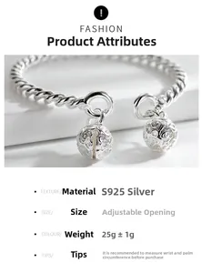 Macro shot of S925 silver twist cuff bracelet featuring dual engraved bell pendants