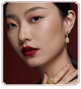 Detailed shot of ethnic earrings and ring set featuring teardrop jade and floral enamel