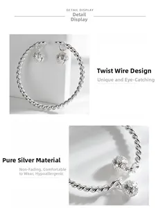 Detailed macro view of silver twisted band bracelet with carved bell charms design