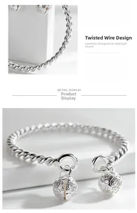 Macro detail of silver twisted rope bracelet with hollow floral bell charms for women