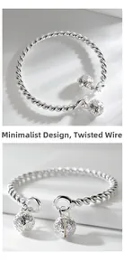 Detailed close-up of a silver twisted wire open bangle with hollow floral bell pendants