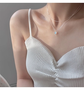 Detail of double-layer S925 silver necklace featuring a blue moonstone heart pendant