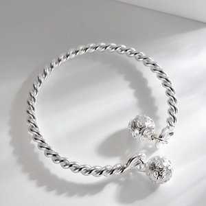 Silver twisted rope bangle with two hollow engraved bell charms in vintage Chinese style