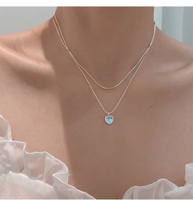 Close-up of double-layer S925 sterling silver heart necklace with iridescent opal pendant