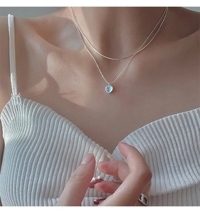 Double-layered 925 silver necklace with heart-shaped moonstone pendant on the model