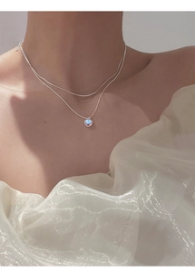 Close-up of double-layer S925 silver heart necklace with blue-purple opal stone on model