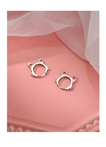 Close-up of S925 sterling silver cat ear hoop earrings on a decorative pink background