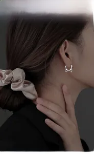 Model wearing a minimalist S925 sterling silver cat-shaped hoop earring for women