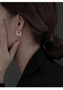 Detailed side view of cat ear silver earrings worn on ear showing high-grade metal texture