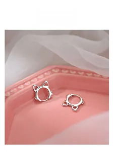 Close-up of cute 925 silver cat-shaped hoop earrings with ear and whisker details