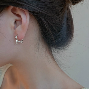 Close-up of cute S925 sterling silver cat ear hoop earring with heart cutout on earlobe