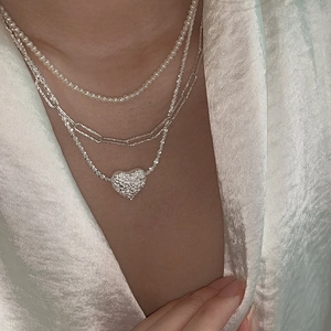 Layered silver necklace set with lava texture heart pendant and elegant white pearls