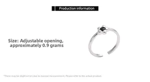 Detail view of flower ring with black diamond inlay and adjustable silver band
