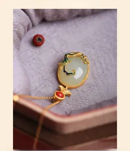 Macro view of Chinese style necklace with white jade pendant and gold dragon detail